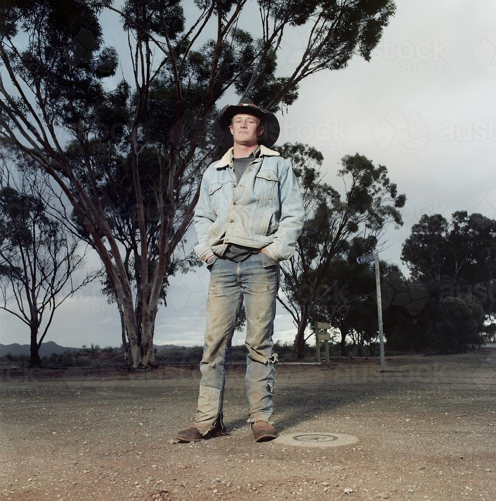 Portrait of young male rural worker standing on street in remote loaction - Australian Stock Image
