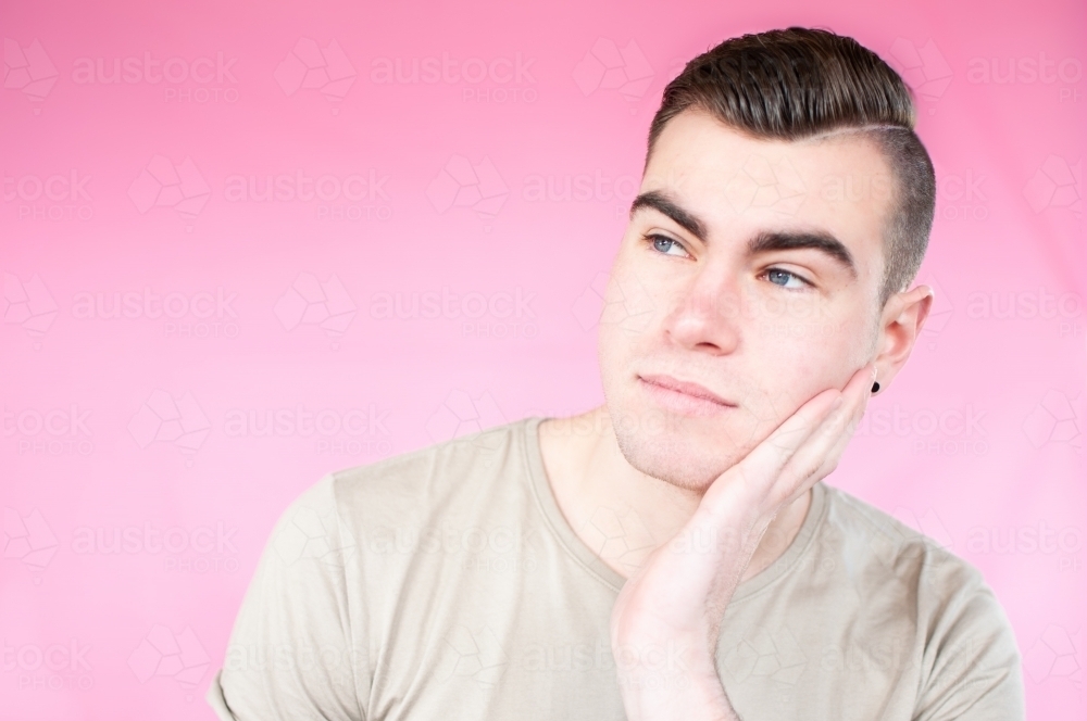 Portrait of young man looking to side - Australian Stock Image
