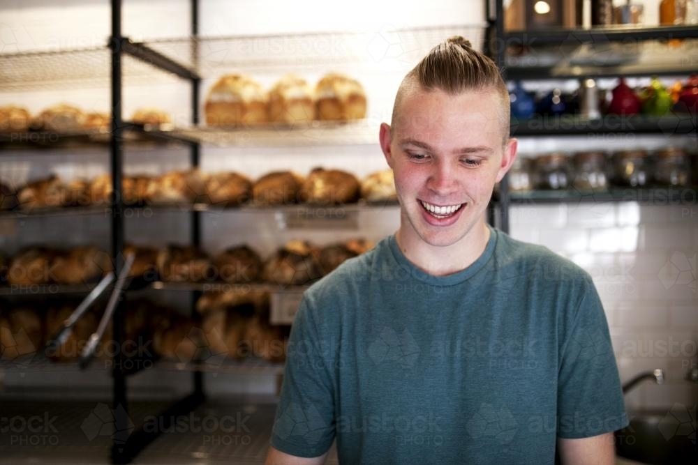 Portrait of young man working at cafe - Australian Stock Image