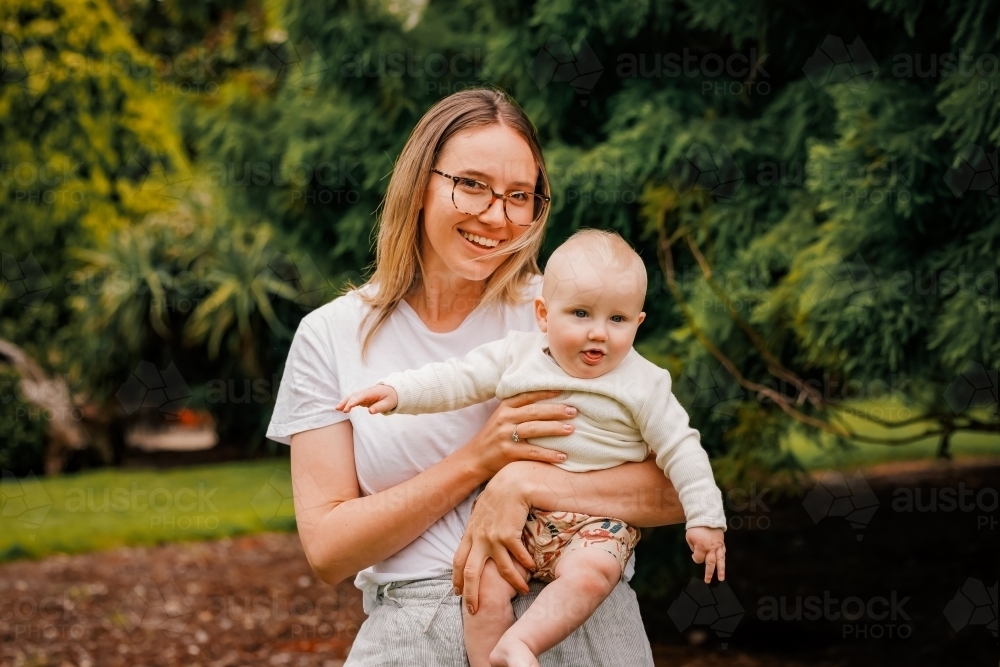 Portrait of young mum and small baby in the park - Australian Stock Image