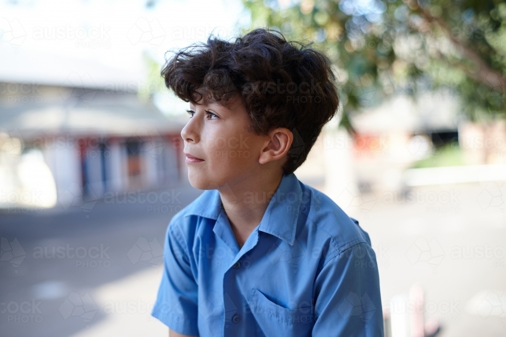 Portrait of young school boy thinking - Australian Stock Image