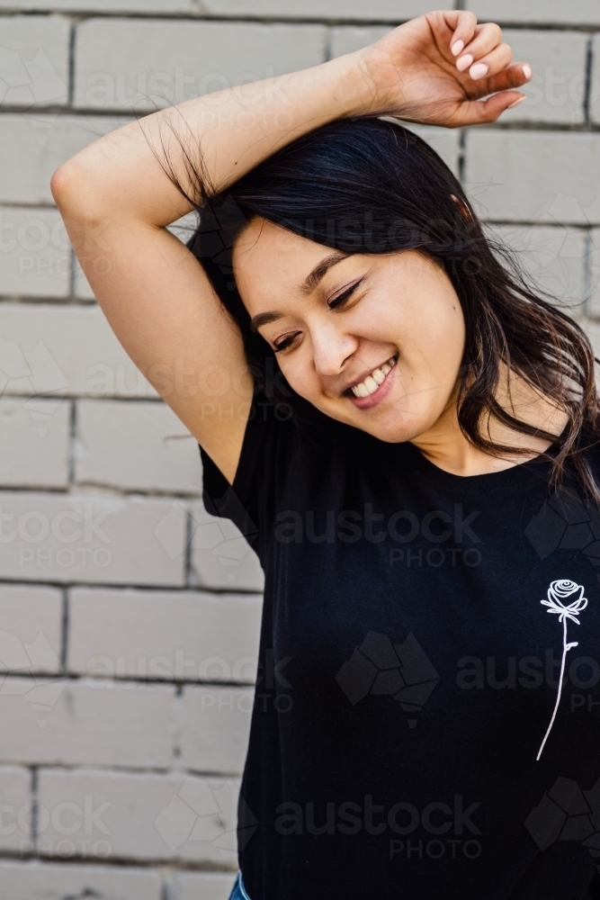 Portrait of young, smiling asian woman - Australian Stock Image