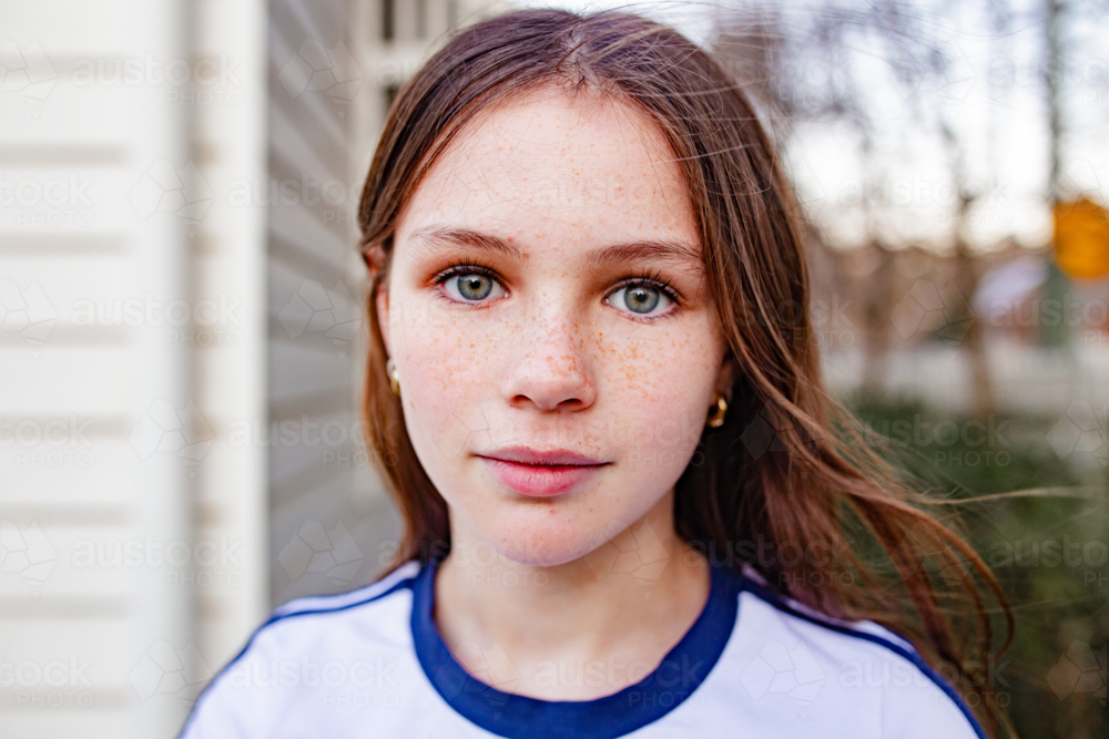 Image of Portrait of young tween girl outside home - Austockphoto