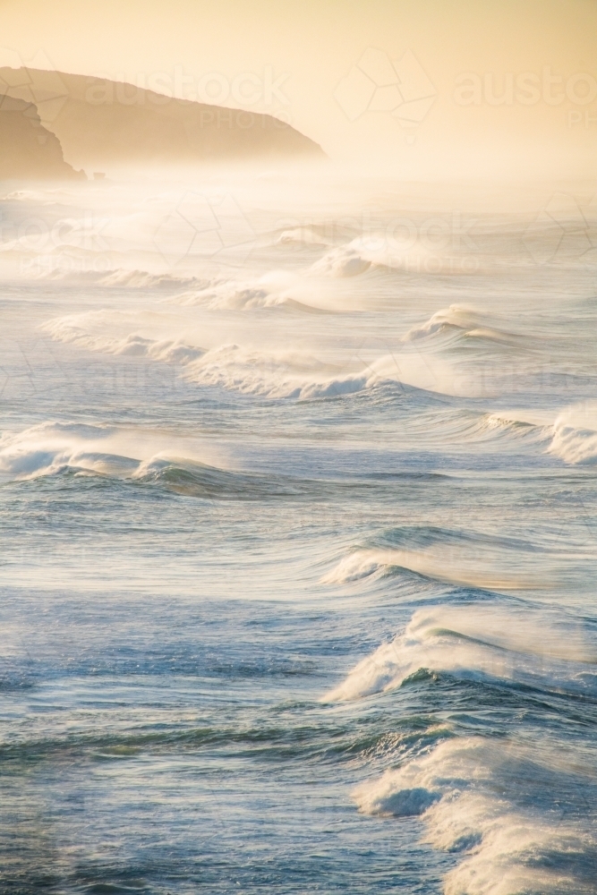 Portrait view of powerful oceans waves in the early morning light. - Australian Stock Image