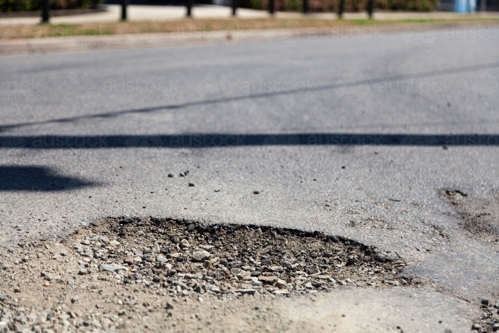 Pot hole in sealed road - Australian Stock Image