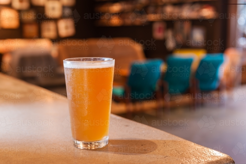 Pot of beer on the counter in a pub - Australian Stock Image