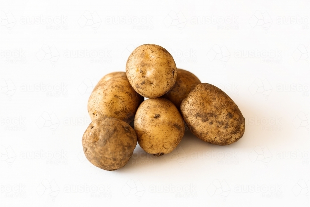 Potatoes on white backdrop - Australian Stock Image