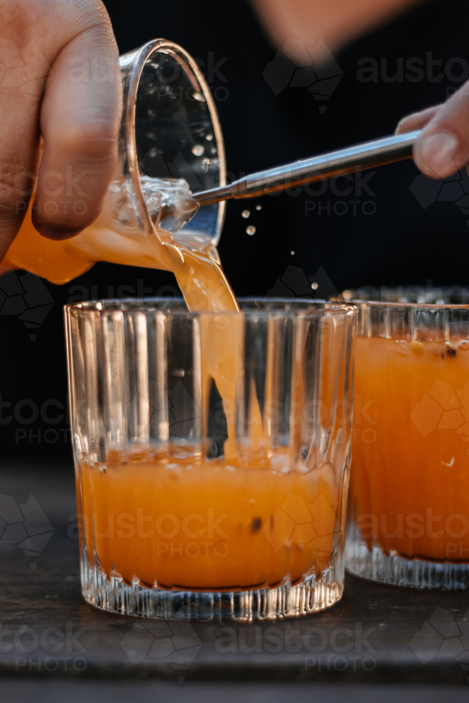 Pouring cocktails into glasses - Australian Stock Image