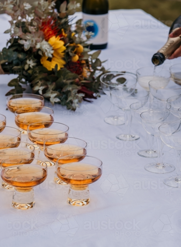 Pouring drinks to celebrate. - Australian Stock Image