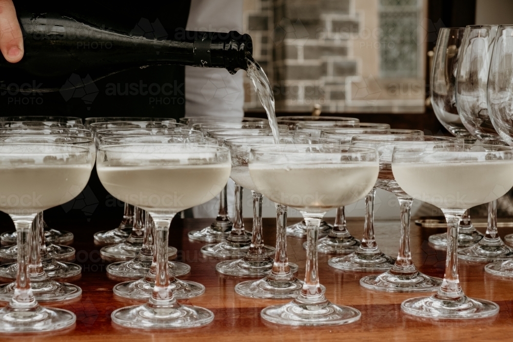 Pouring sparkling wine. - Australian Stock Image
