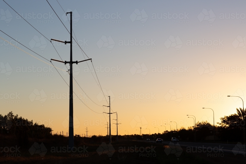 Power lines and street lights in silhouette - Australian Stock Image
