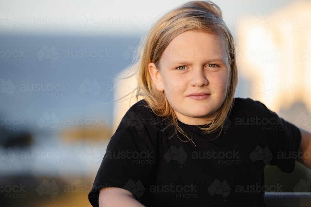 Pre-teen boy standing on balcony of high rise building on the Gold Coast with view - Australian Stock Image