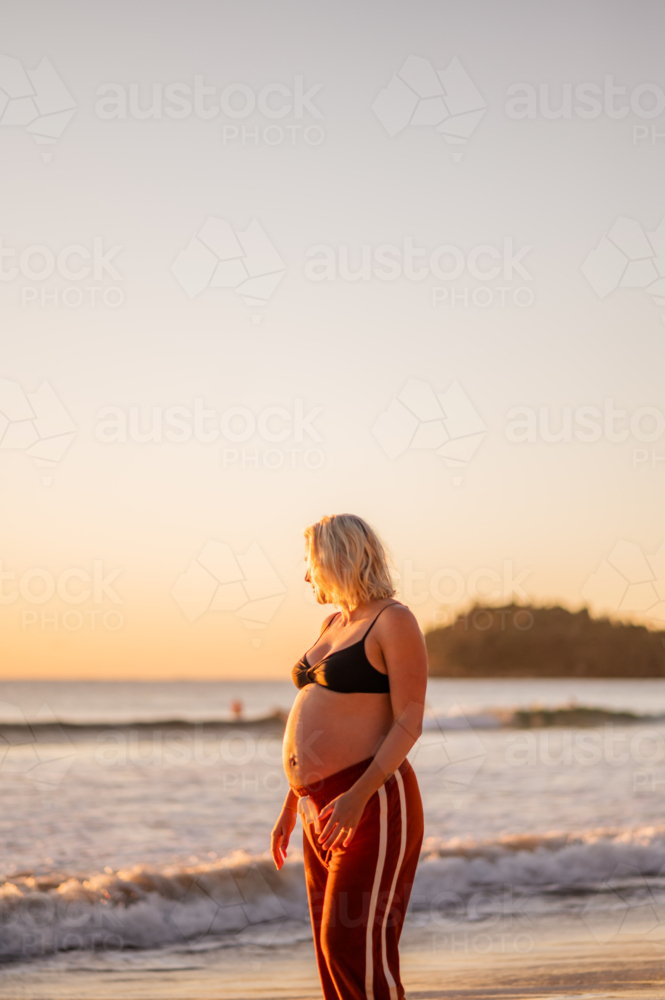 pregnant woman at Manly Beach during sunrise - Australian Stock Image