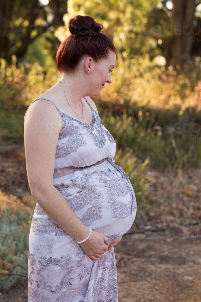 Image of Pregnant woman in natural bush setting - Austockphoto