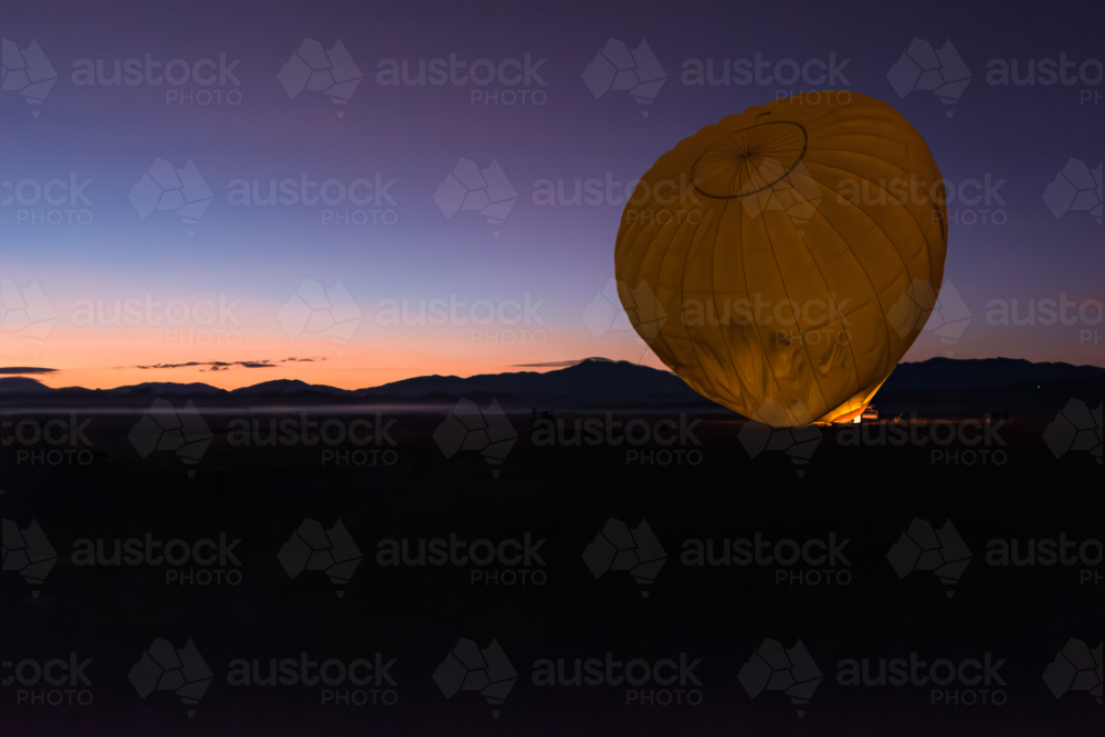 Prepping the hot air balloon at sunrise in Mareeba in the Atherton Tablelands - Australian Stock Image