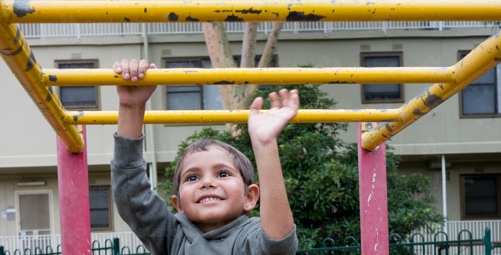 Preschool Aged Aboriginal Boy on Playground Equipment - Australian Stock Image