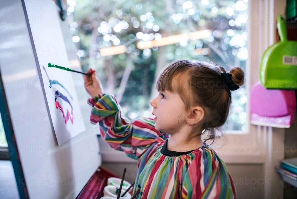 Preschool girl painting a picture - Australian Stock Image