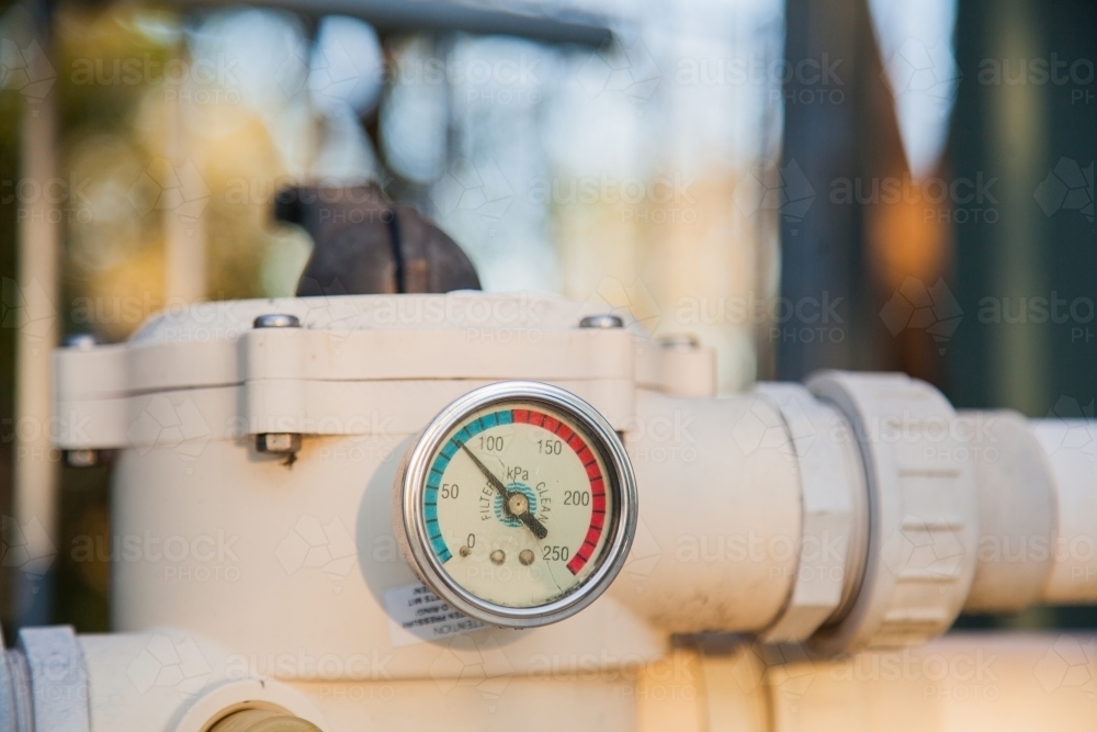 Pressure gauge on old pool pump sand filter - Australian Stock Image