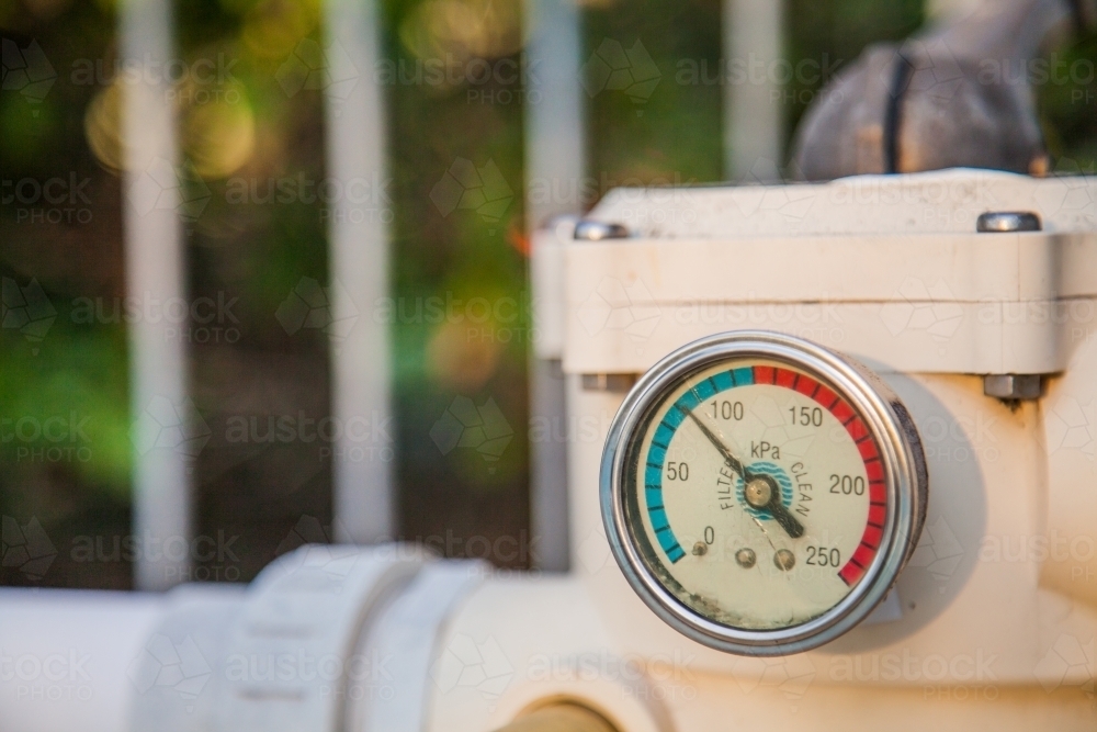 Image of Pressure gauge on old pool pump sand filter Austockphoto