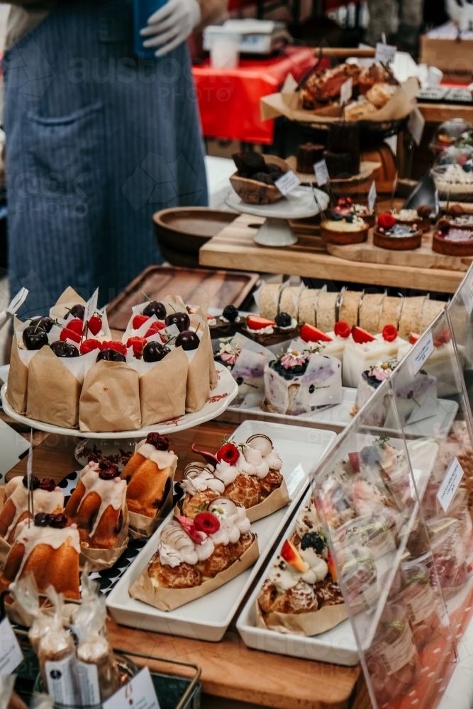 Pretty cakes at a cake stall. - Australian Stock Image