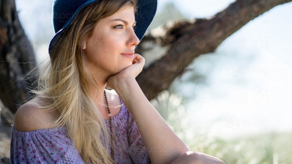Pretty girl close up looking pensive on beach - Australian Stock Image