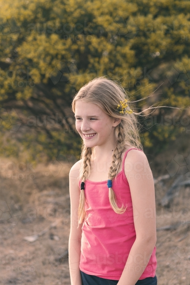 Pretty tween girl with wattle in her hair - Australian Stock Image