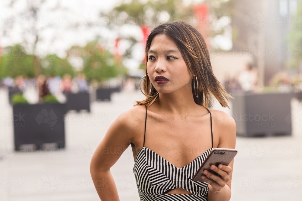 pretty young woman using phone - Australian Stock Image