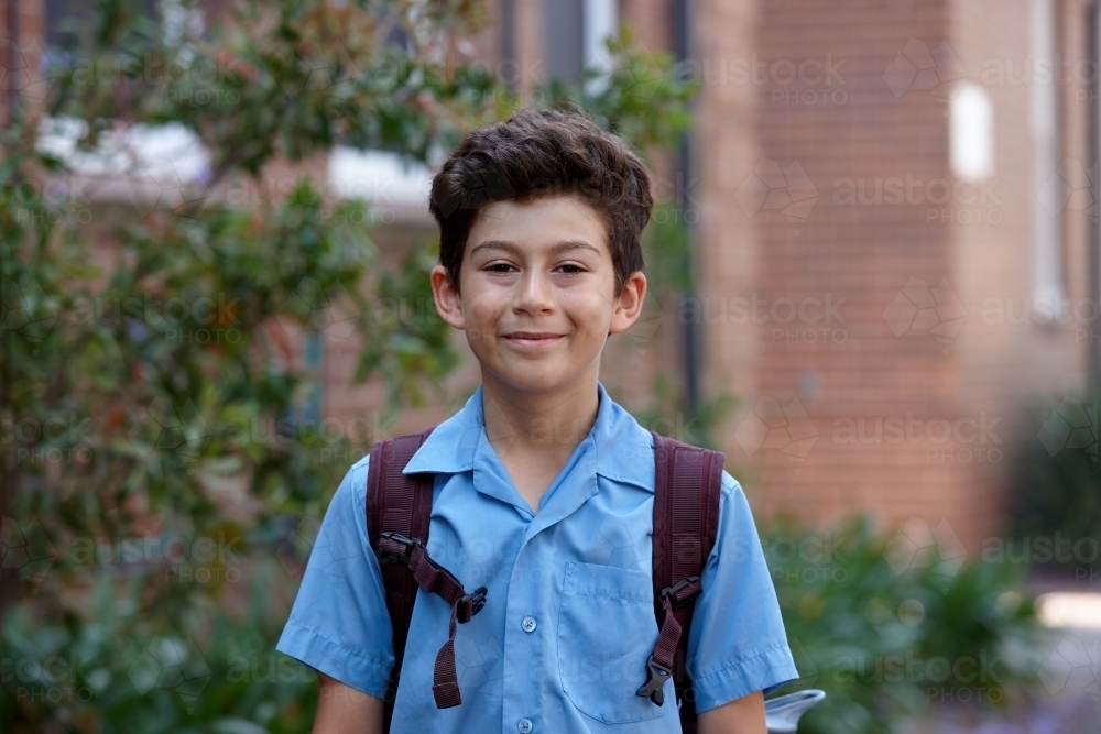 Primary school student at school with backpack - Australian Stock Image