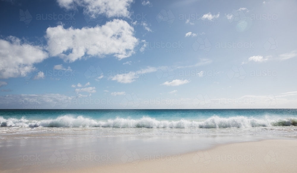 Pristine beach looking out to sea in morning light - Australian Stock Image