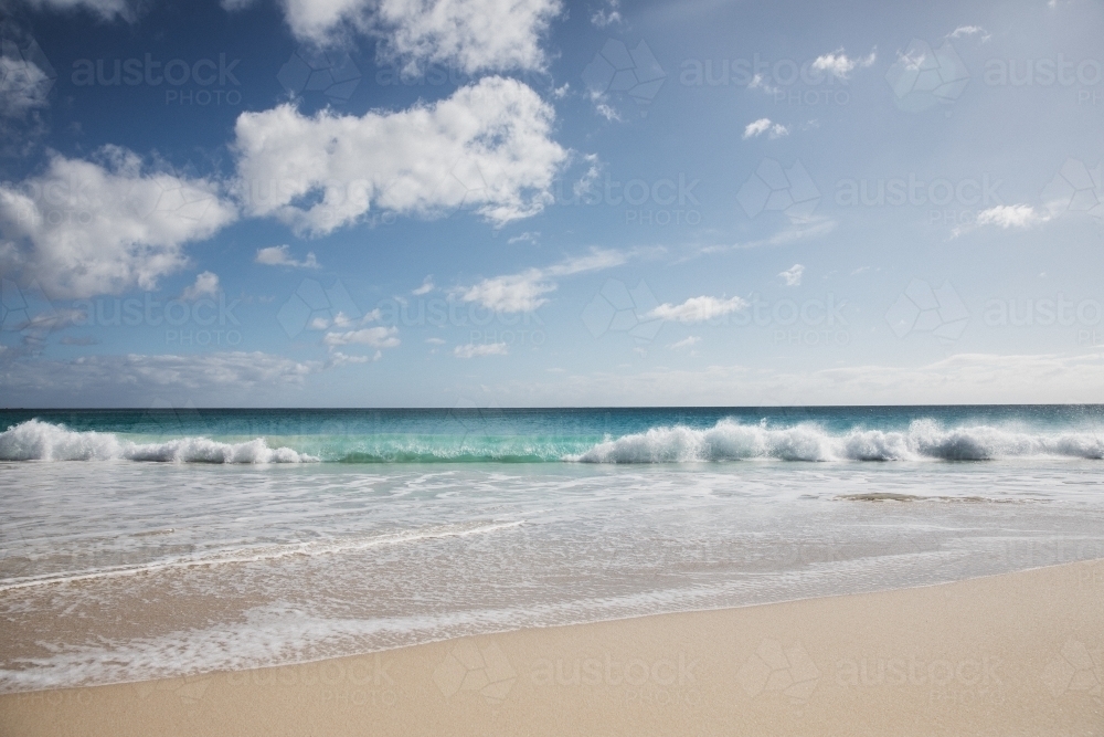 Pristine beach looking out to sea in morning light - Australian Stock Image