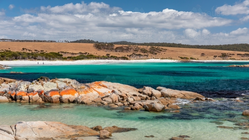 Pristine turquoise water, white sand & orange rocks at Bay of Fires, Tasmania - Australian Stock Image