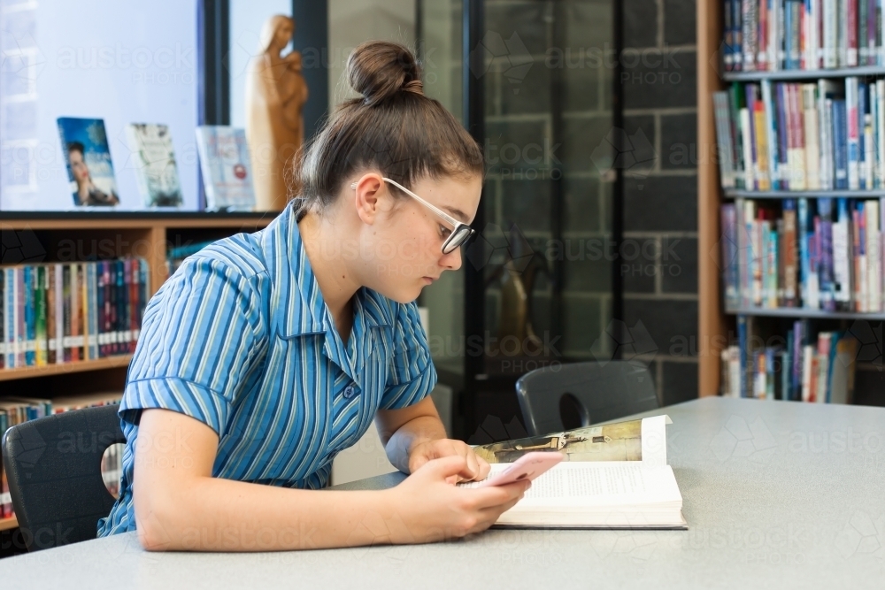 private girls school student studying in the library - Australian Stock Image