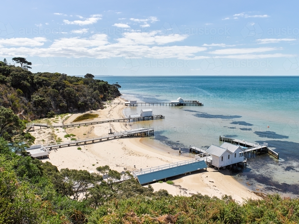 private jetties & boat sheds from cliffside walkway - Australian Stock Image