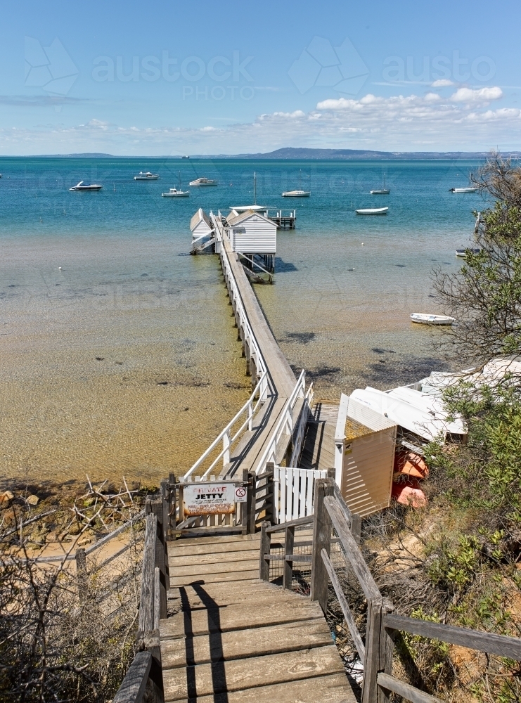 Private jetty & boat shed from cliffside walkway - Australian Stock Image