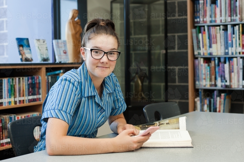 private school girl student studying in the library - Australian Stock Image
