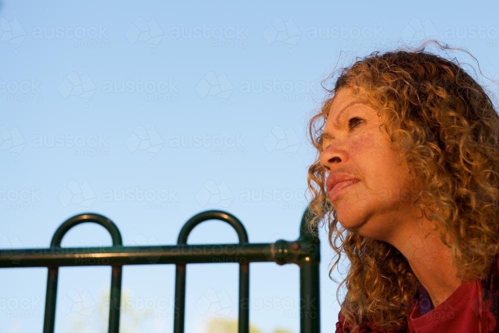Profile of an Aboriginal Woman against a Blue Sky - Australian Stock Image