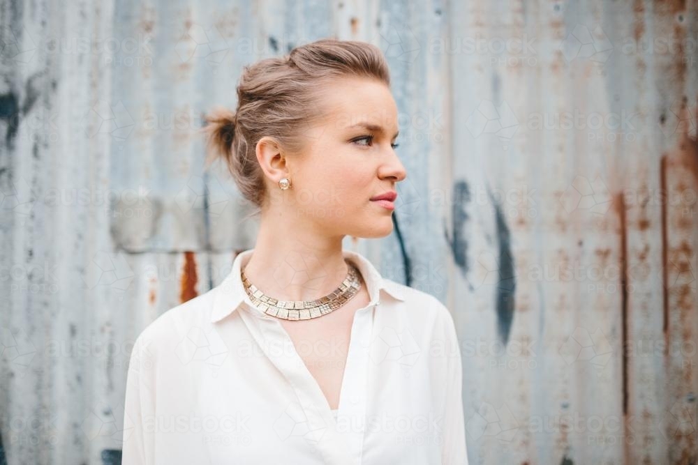 Profile of woman in industrial setting - Australian Stock Image