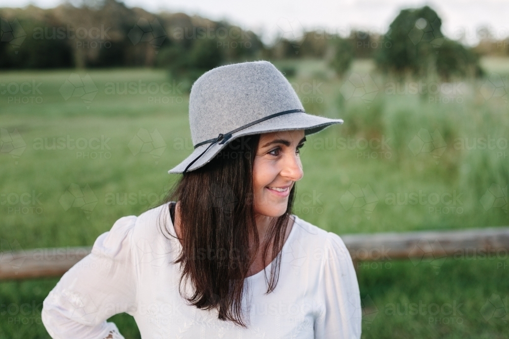 Profile of young woman outdoors smiling - Australian Stock Image