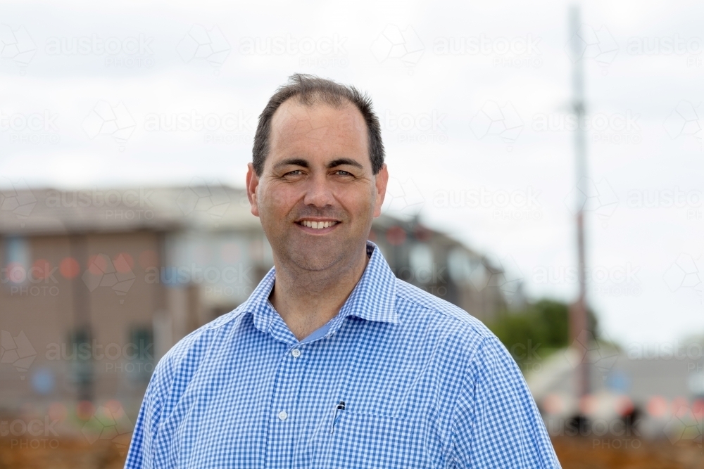 Property developer smiling on-site - Australian Stock Image