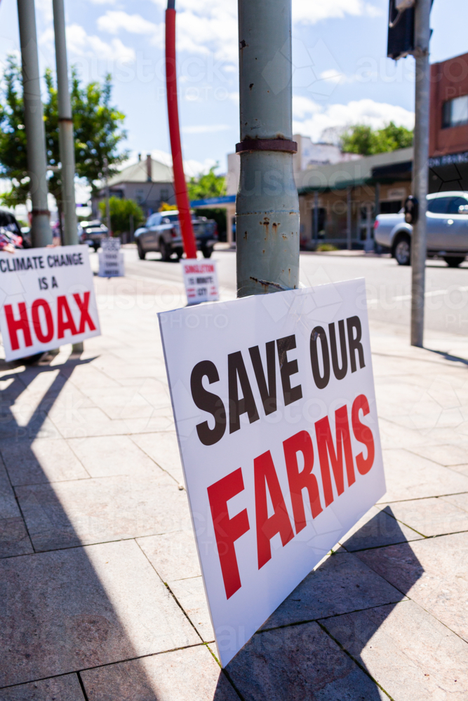 Protest sign set up on pavement along street of country town of Singleton in Hunter Valley - Australian Stock Image