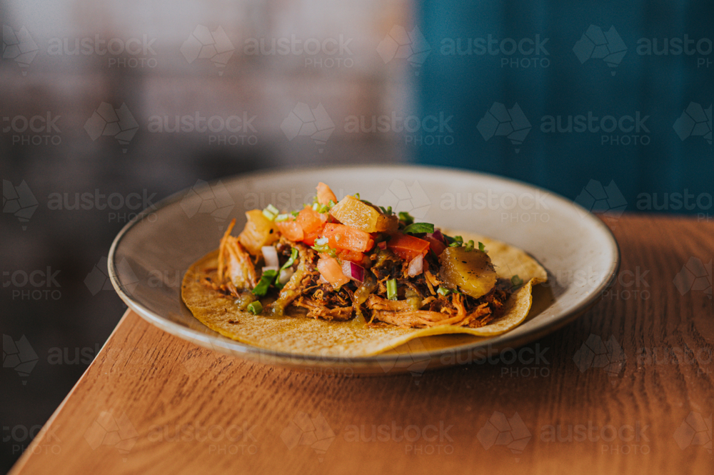 Pulled pork Mexican Taco with fresh guacamole and tomato - Australian Stock Image