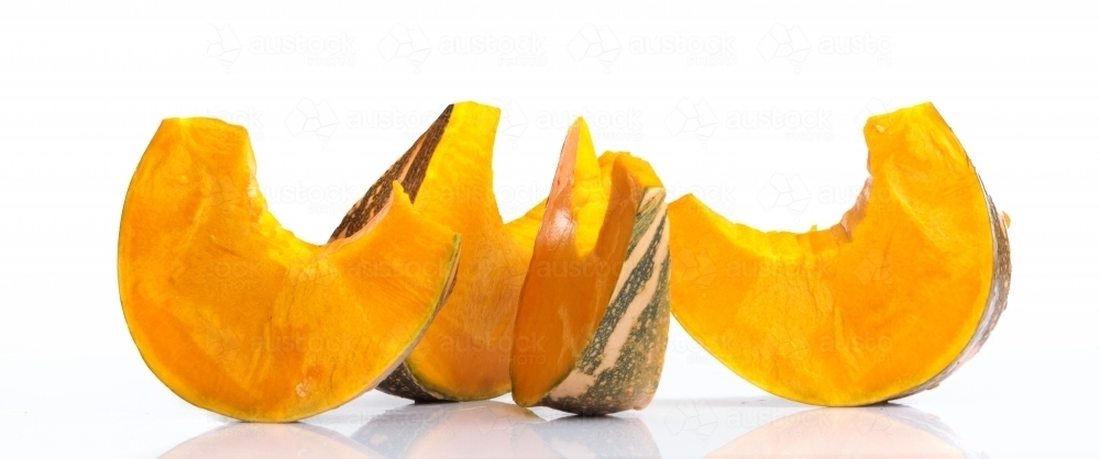 Pumpkin slices on white background - Australian Stock Image
