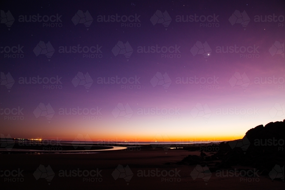 Purple dawn, early morning at low tide - Australian Stock Image