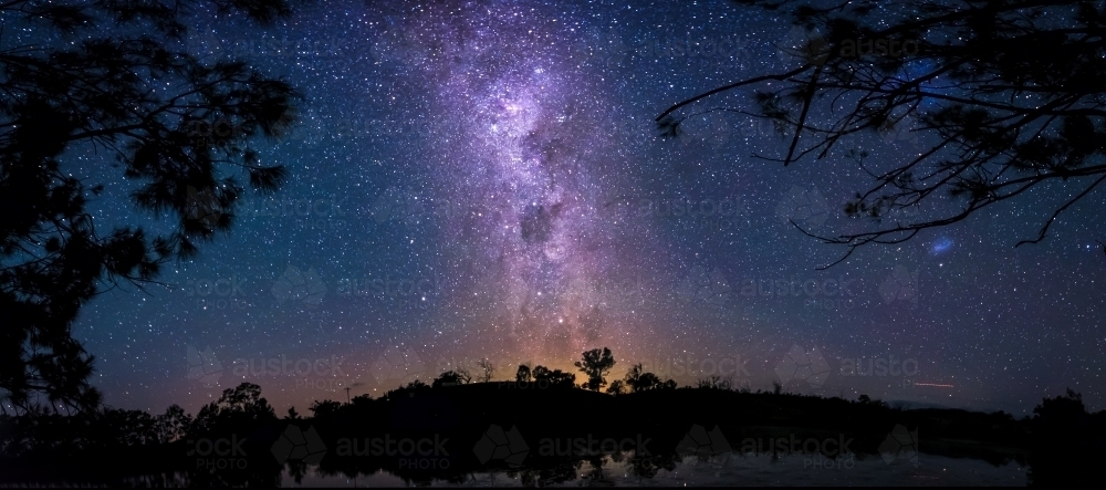 Purple milky way behind bushland - Australian Stock Image