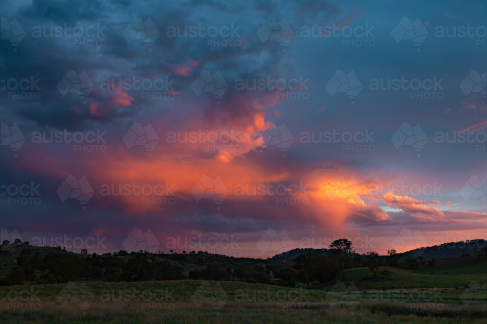 Image of Purple storm clouds over the Australian landscape at sunset ...