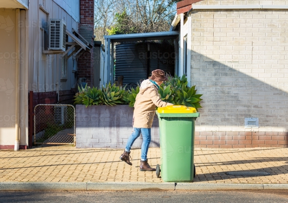 Putting rubbish bin out on the street - Australian Stock Image
