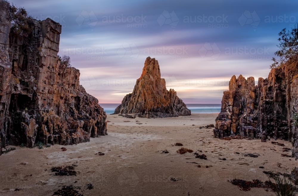 Pyramid rock sea stack long exposure movement of clouds across the sky during the dawn sunrise. - Australian Stock Image