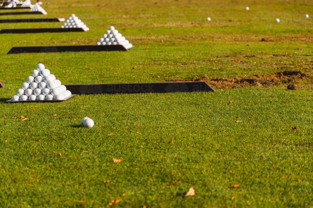 Pyramids of golf balls on a driving range - Australian Stock Image