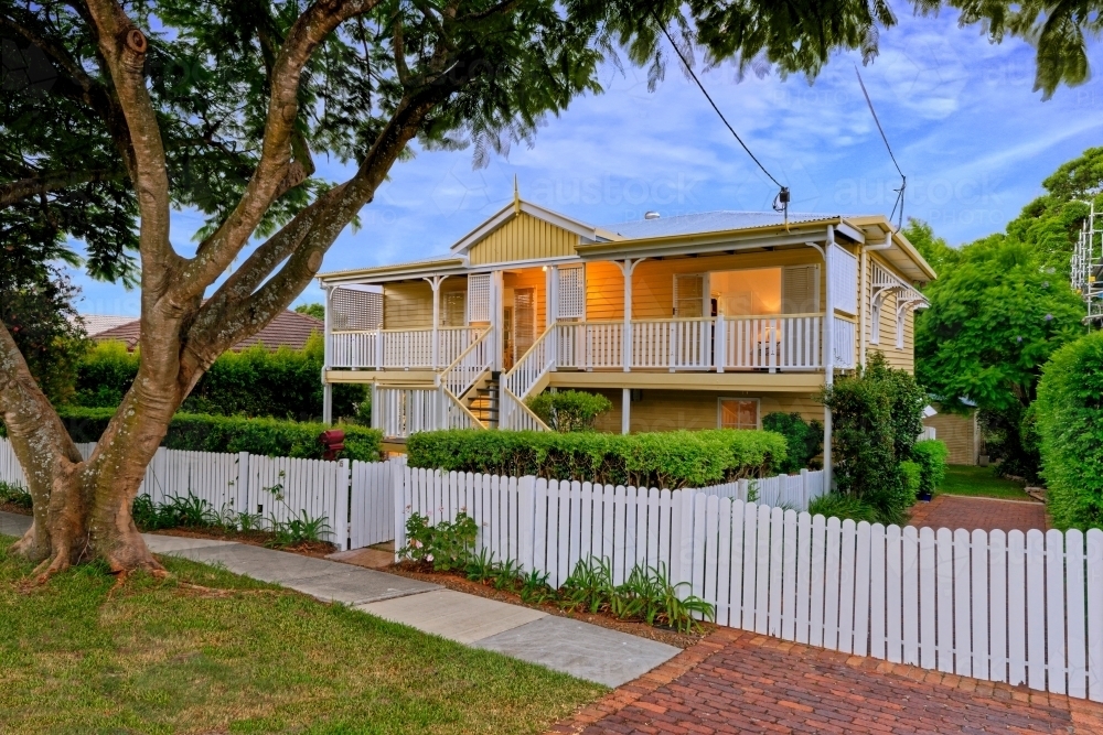 Queenslander home in Brisbane photographed at dusk - Australian Stock Image