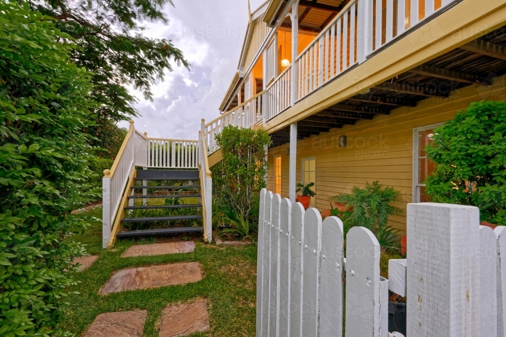 Queenslander home in Brisbane photographed at dusk - Australian Stock Image